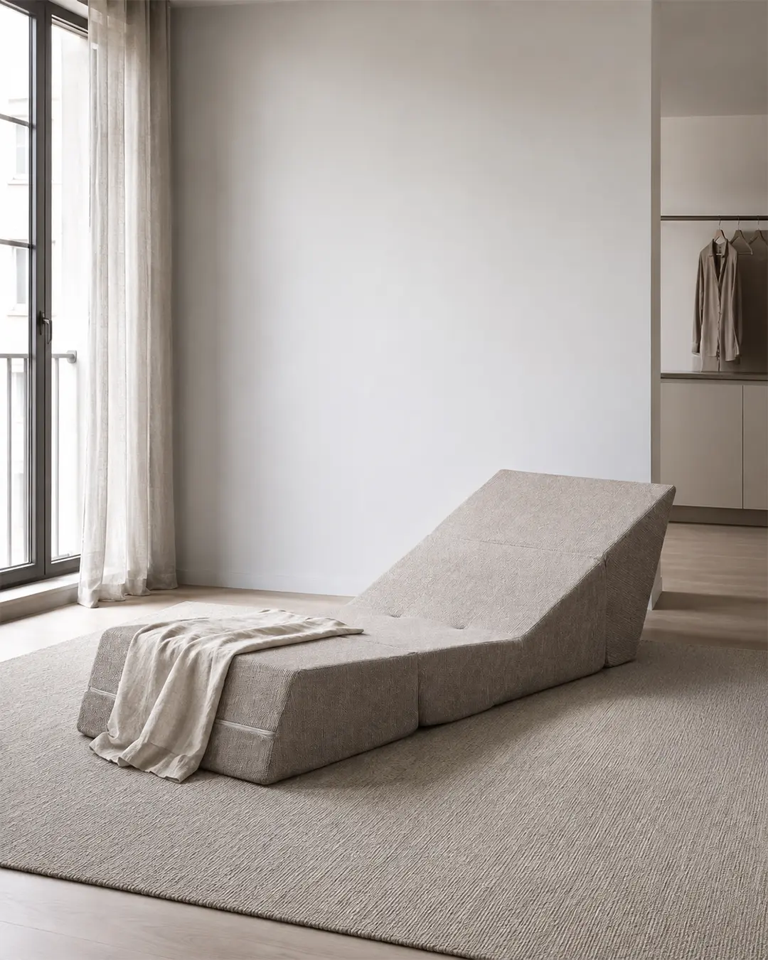 Amy upholstered armchair in beige fabric, shown vacuum-packed in a minimalist room