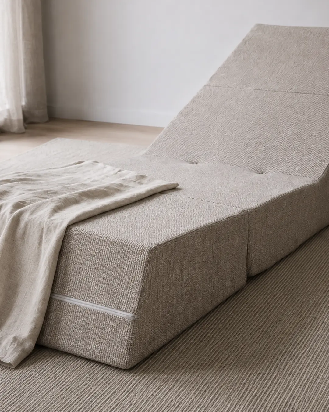 Amy Upholstered Armchair in textured beige fabric with matching throw blanket