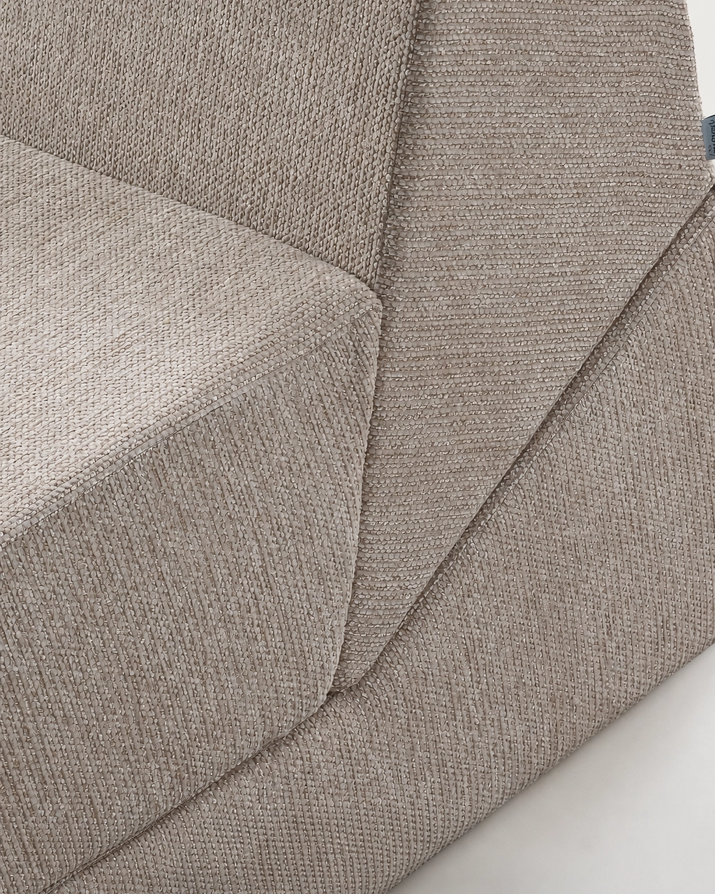 Amy Upholstered Armchair close-up with textured beige fabric upholstery
