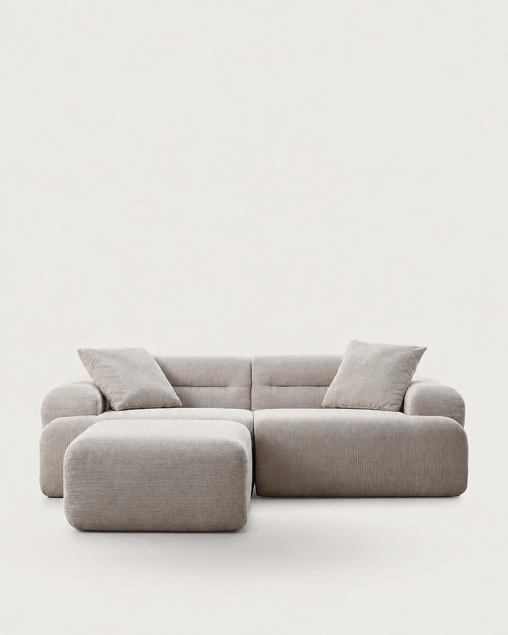 Elvis 3-piece modular sofa with two pillows and ottoman in sand beige textured fabric front view