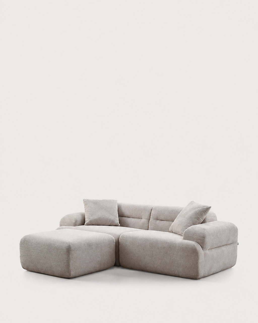 Elvis 3-piece modular sofa with ottoman and two pillows in sand beige textured fabric