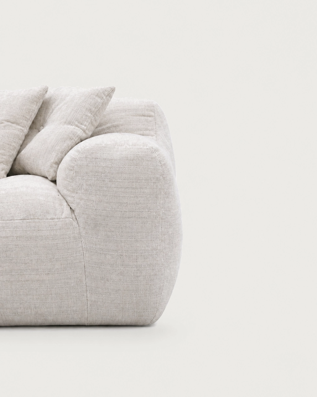Detail of Marley 2-Seater Modular Sofa armrest in textured off-white fabric upholstery