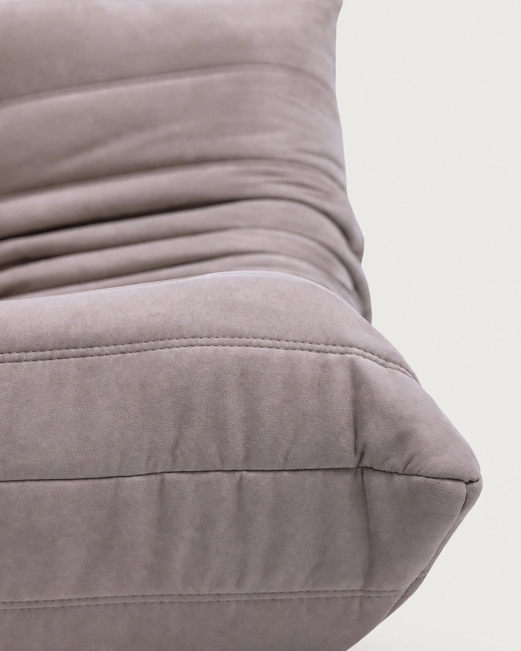 Close-up of Paco 2-Seater Upholstered Armchair seater in taupe fabric