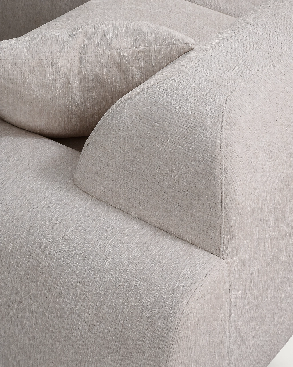 Detail of Sinatra Modular Sofa back and armrest with textured off-white fabric upholstery