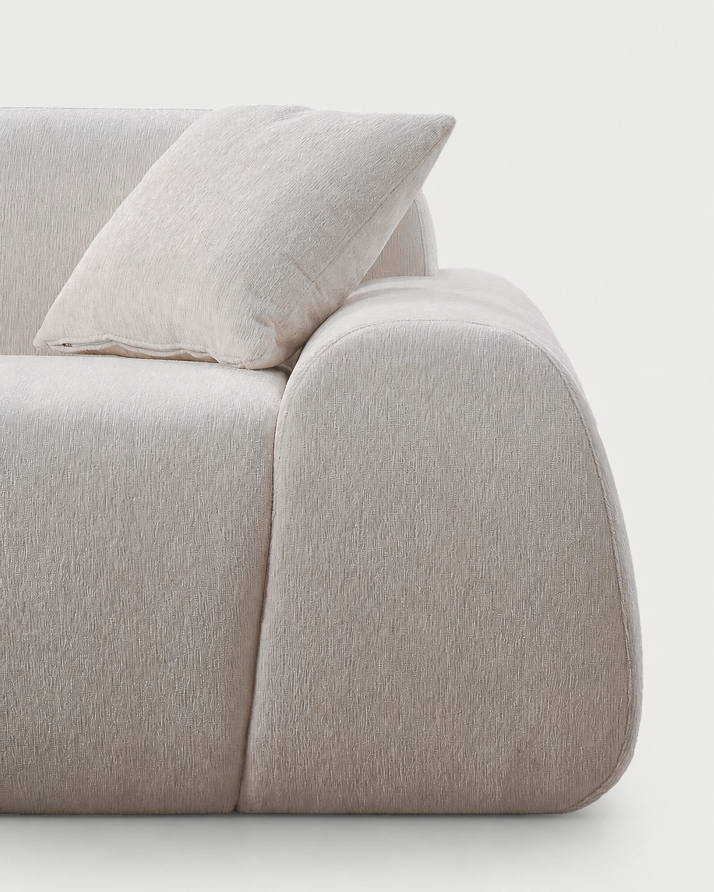 Sinatra Modular Sofa in textured off-white fabric with rounded armrest and cushion