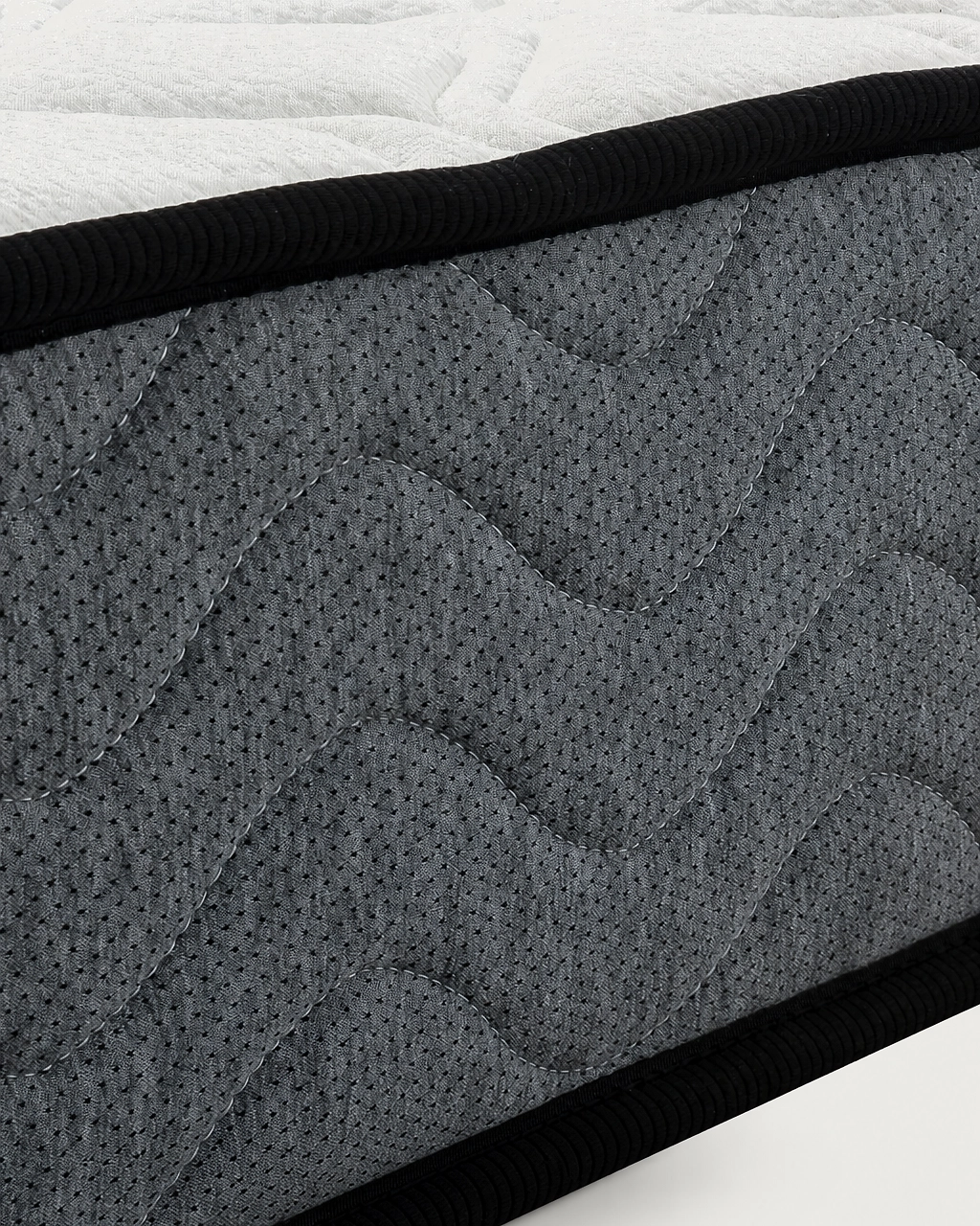 Tina vacuum-packed mattress with quilted gray fabric sides and black piping